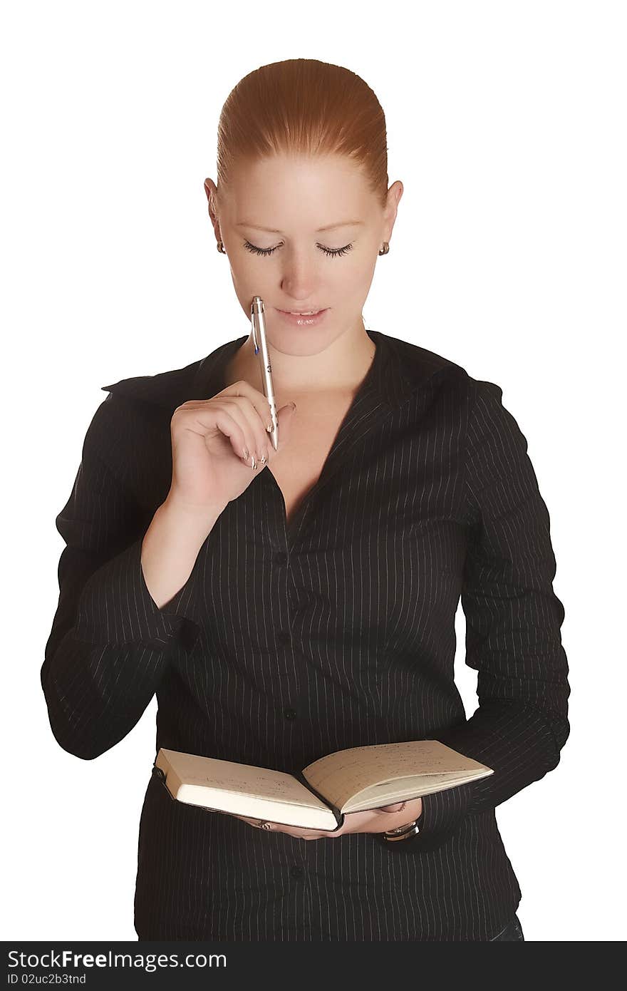 Young red haired lady thinking with her notebook and pen. Young red haired lady thinking with her notebook and pen