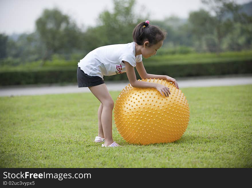 Asian girl play ball on grass. Asian girl play ball on grass