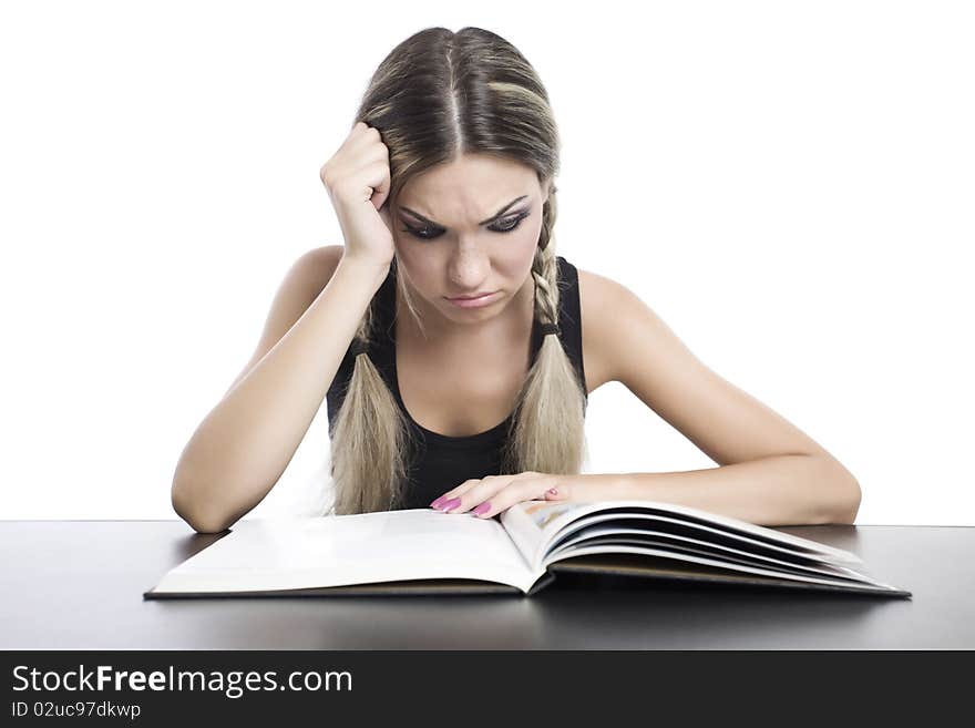 Young pretty girl reading a book