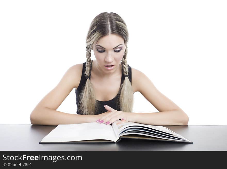 Young pretty girl reading a book