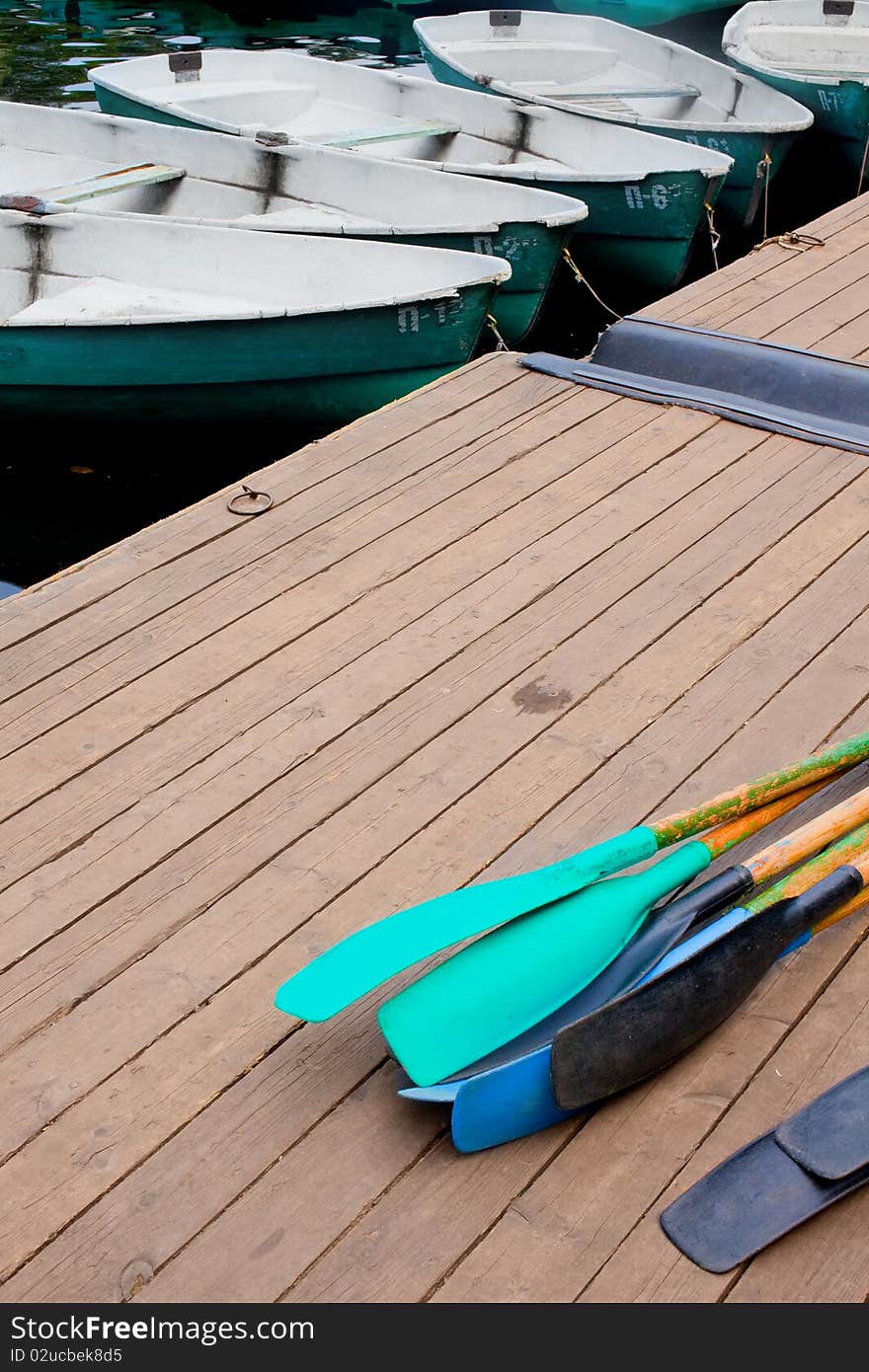 Green boat on the water near the pier