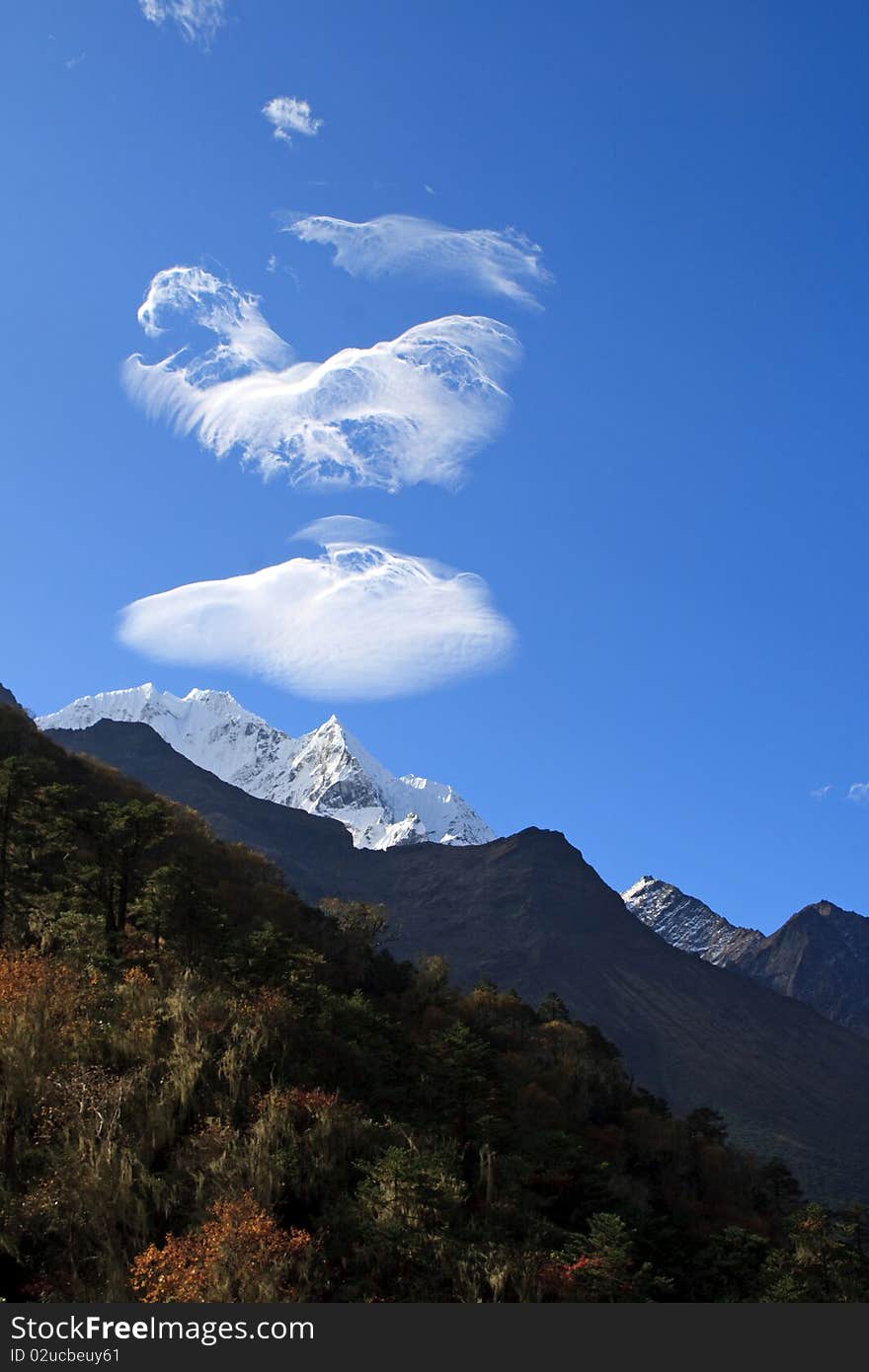 The mountains in the Himalayas look as though they are sending smoke messages. The mountains in the Himalayas look as though they are sending smoke messages.