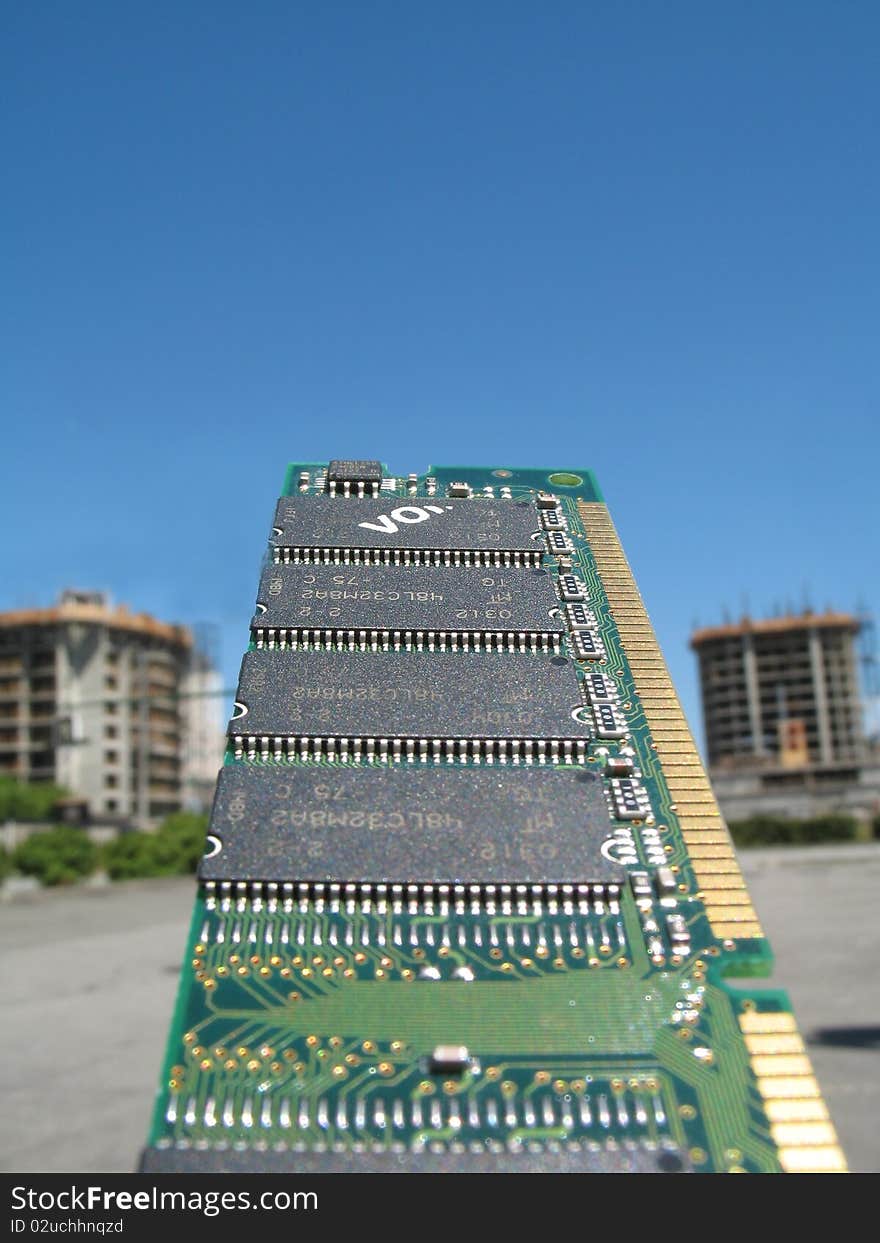 Computer chip held up to a clear blue sky in background. Computer chip held up to a clear blue sky in background.