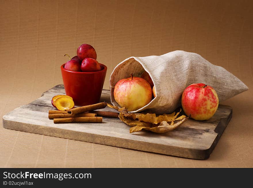 Still-life with apples, plums and cinnamon. Still-life with apples, plums and cinnamon