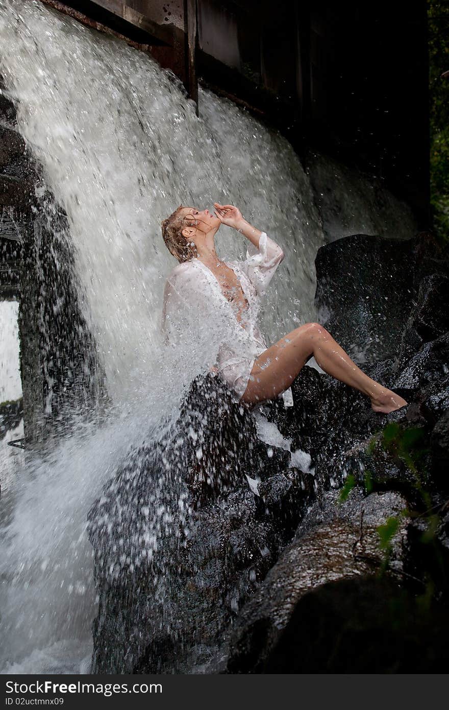 Young Woman Near The Waterfall