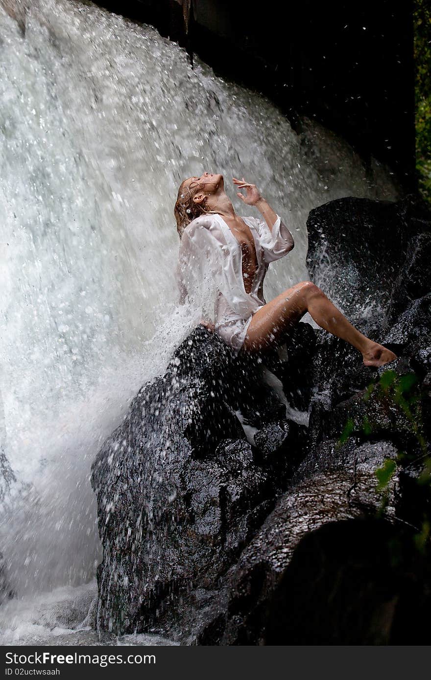 Young Woman Near The Waterfall