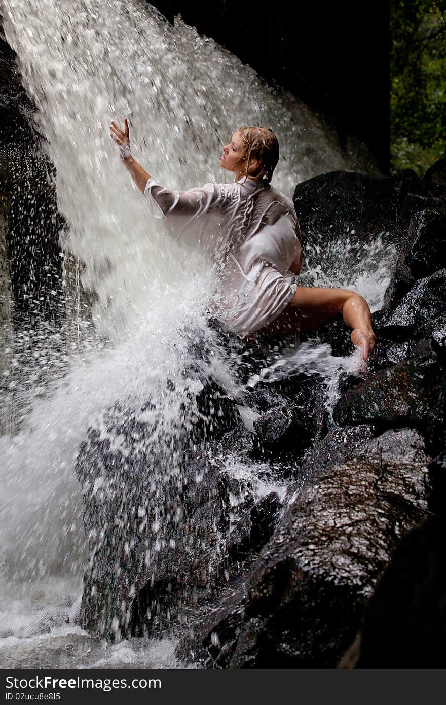 Young Woman Near The Waterfall