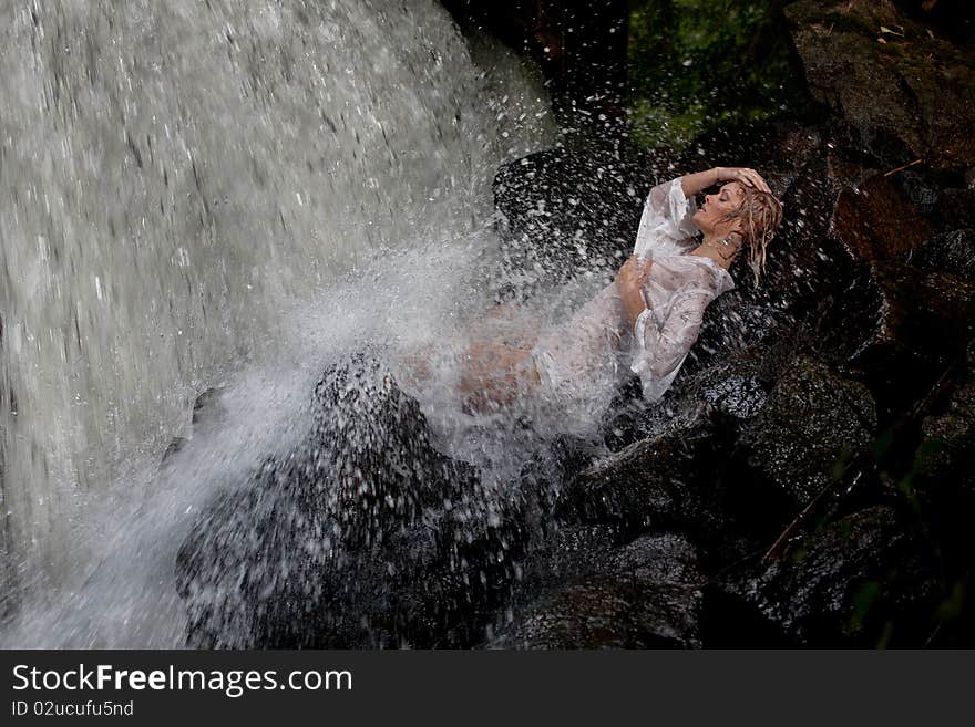 Young Woman Near The Waterfall