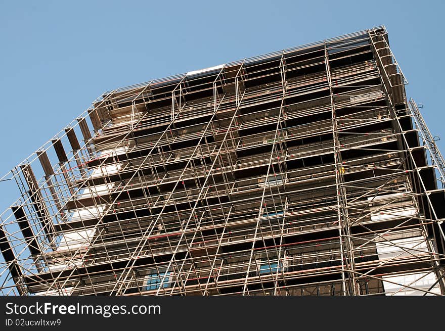 Building under construction in scaffolding