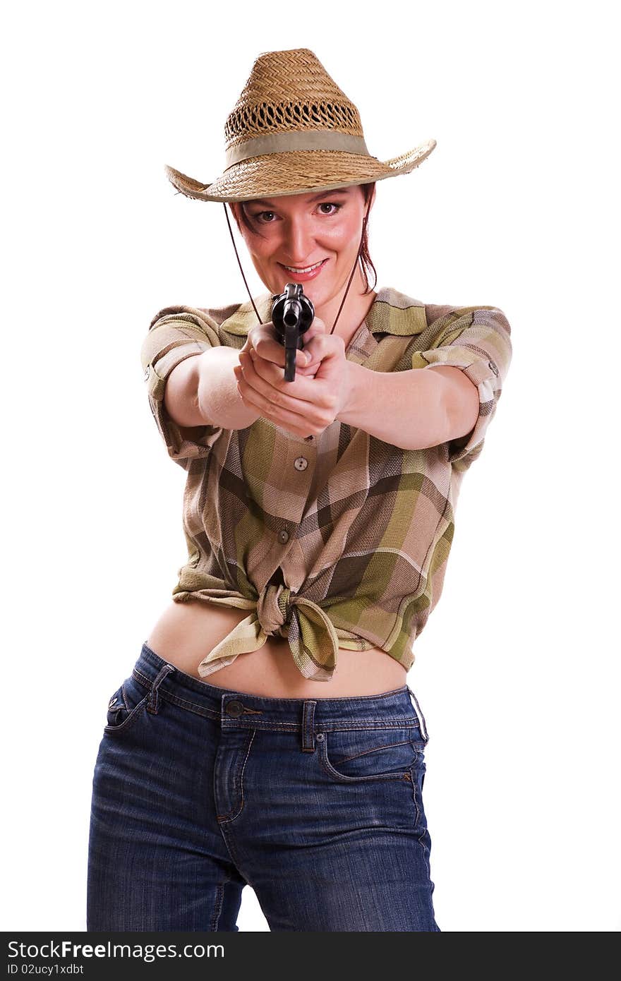 Super rodeo cowgirl in torn jeans, boots and cowboyhat. Portrait of Cowboy Holding Gun Up.