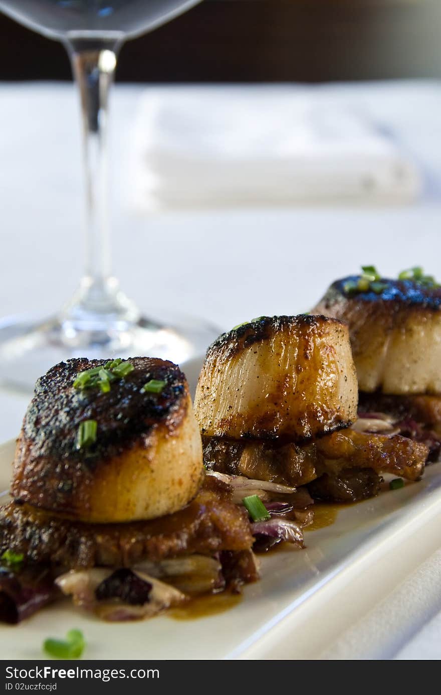 Pan seared scallops over pork belly