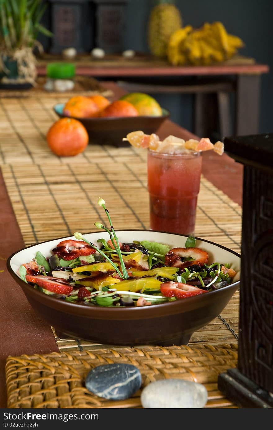 Organic fresh fruit salad with candied ginger tea