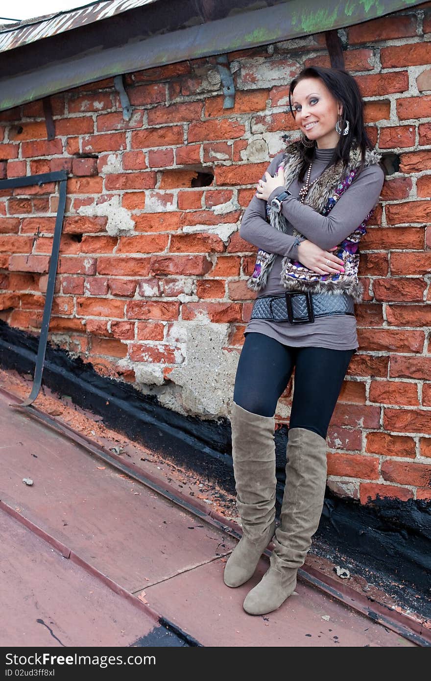 Portrait of a girl on the roof. Brick wall separates two houses. Portrait of a girl on the roof. Brick wall separates two houses