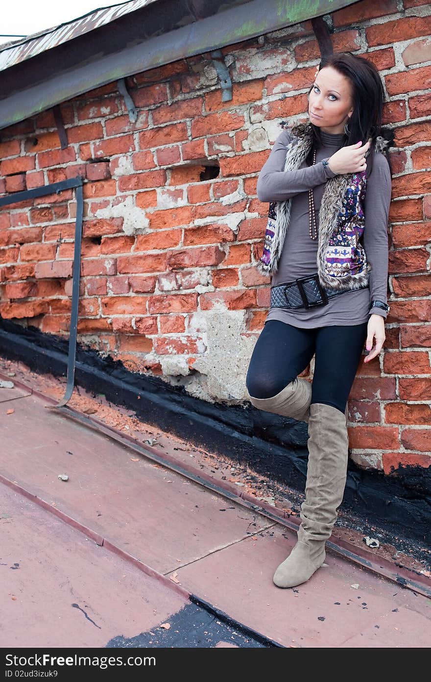 Portrait of a girl on the roof. Brick wall separates two houses. Portrait of a girl on the roof. Brick wall separates two houses