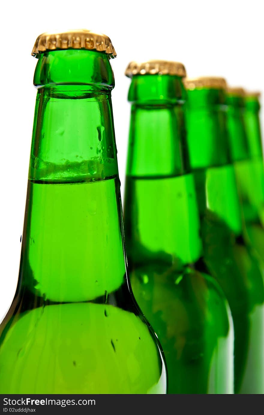 Row from beer bottles. Isolated on white background