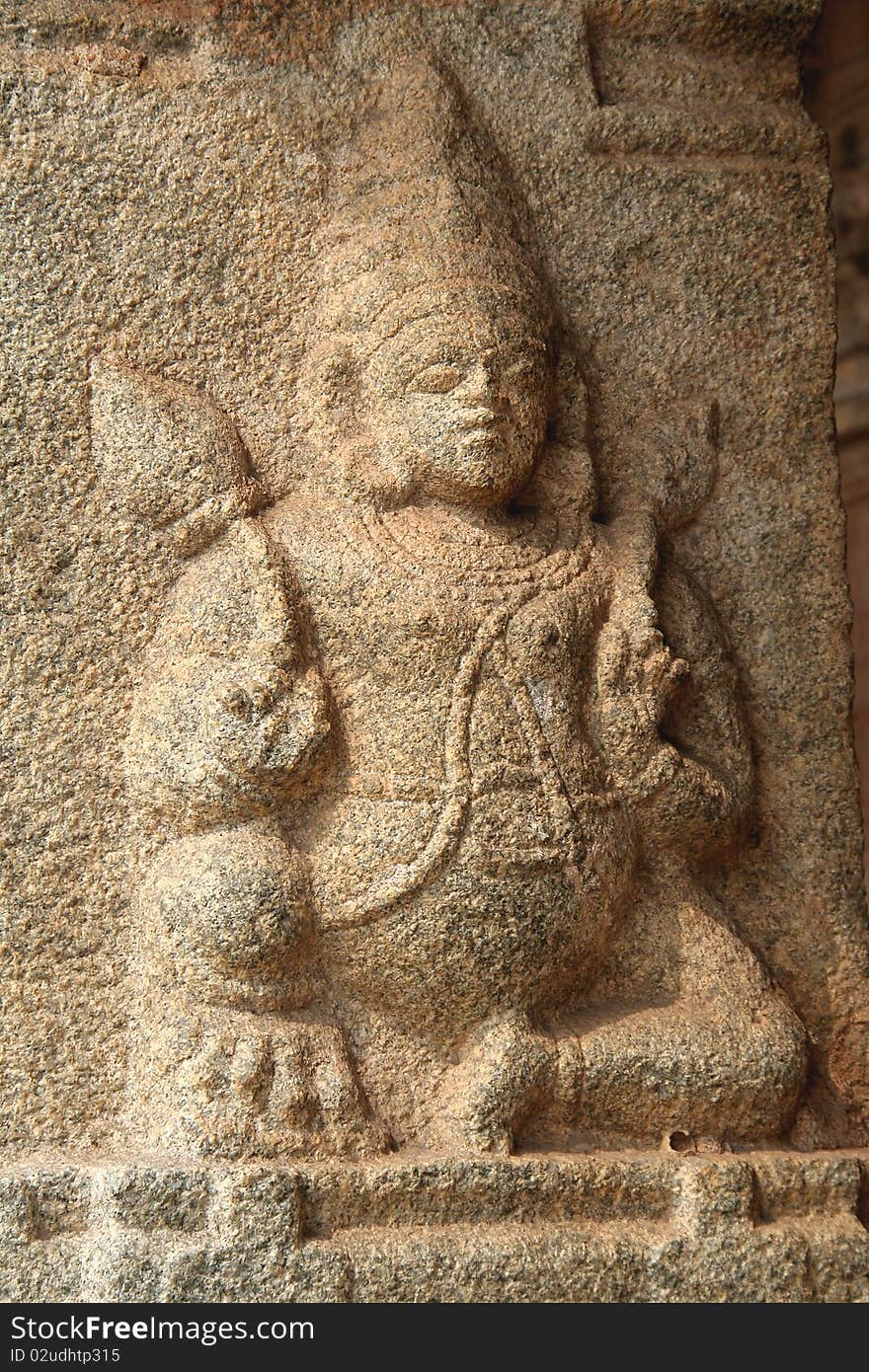 Figure in sedentary posture holding lotus buds at Krishna Temple, Hampi, Karnataka, India, Asia. Figure in sedentary posture holding lotus buds at Krishna Temple, Hampi, Karnataka, India, Asia