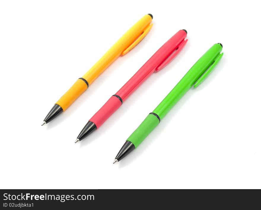 Colored pens on a white background