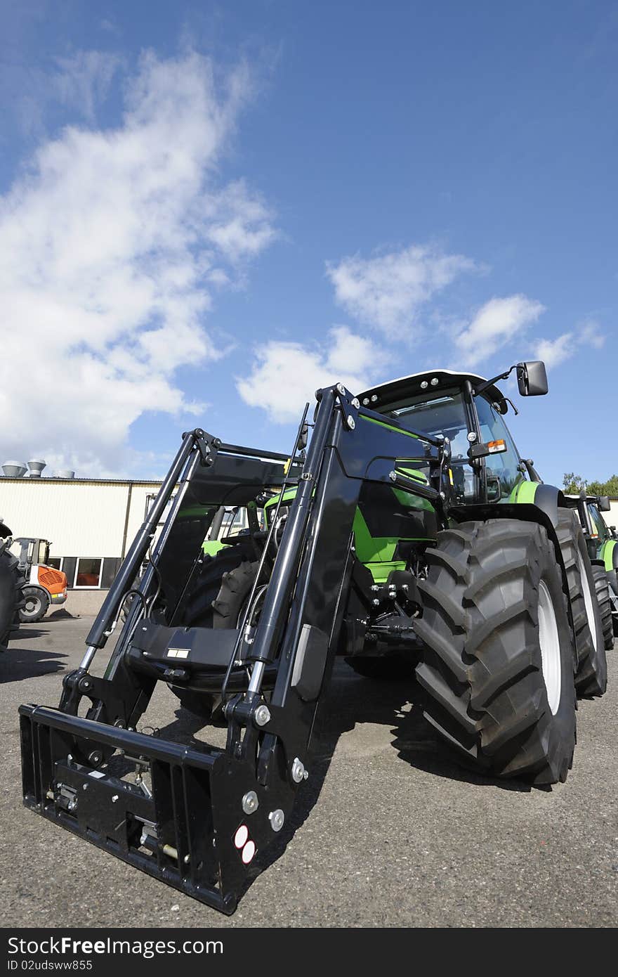 New tractors standing on line, trademarks removed. New tractors standing on line, trademarks removed