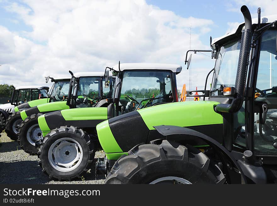 New tractors standing on line, trademarks removed. New tractors standing on line, trademarks removed