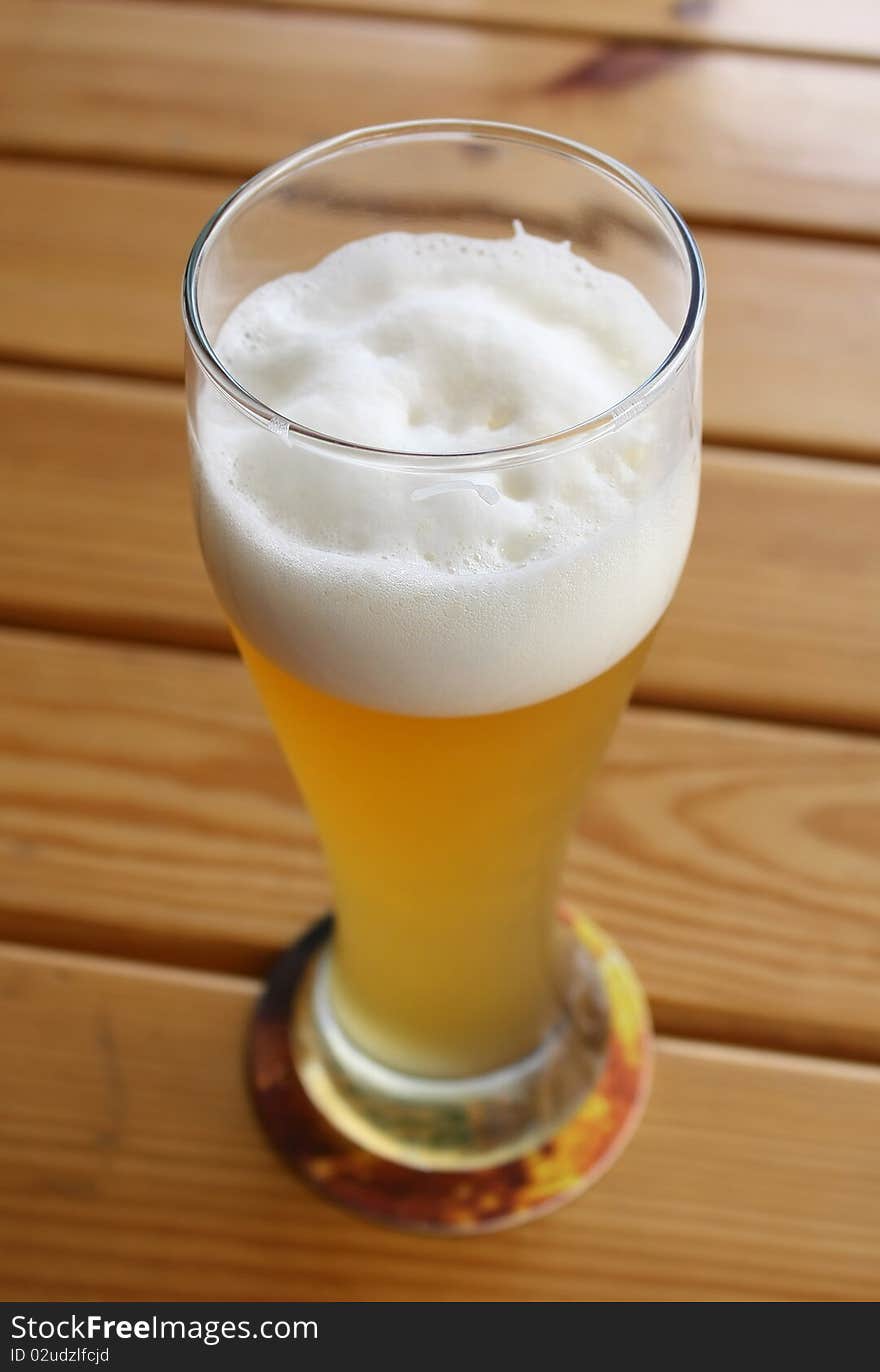 Beer in glass on a wooden table