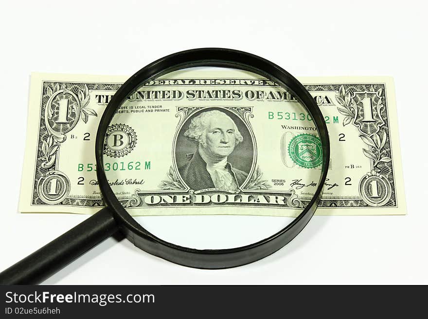 US dollar with a magnifier on a white background. US dollar with a magnifier on a white background