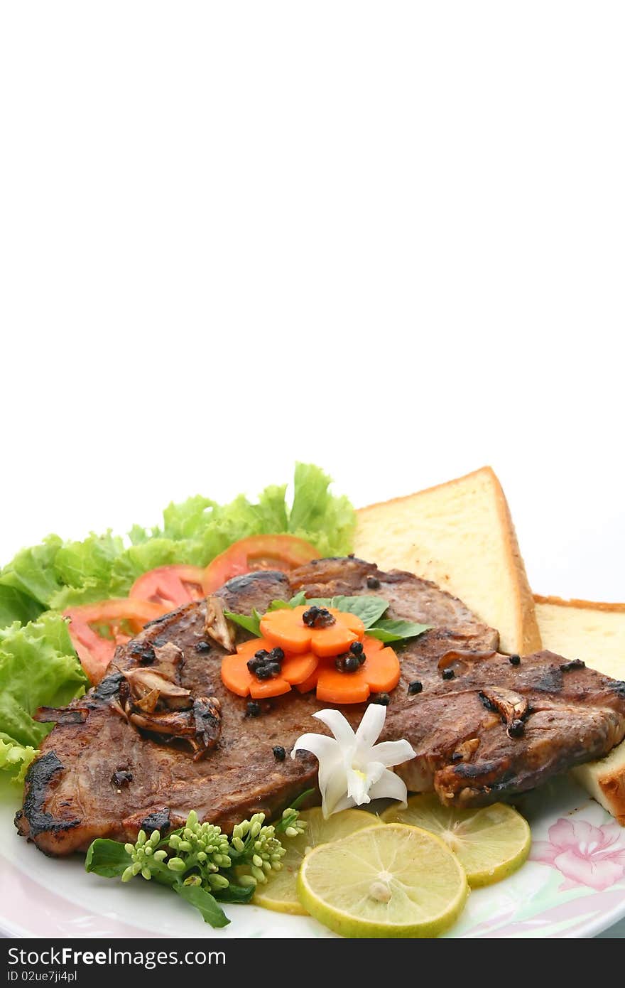 T Bone Pepper Steak with vegetable and bread, closeup