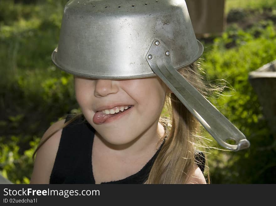 Little girl grimacing and sticking out tongue