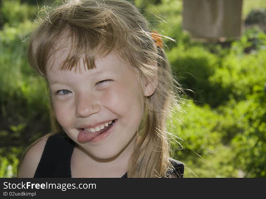 Little girl sticking out tongue.