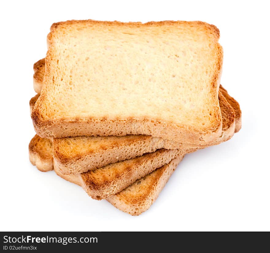 A pile of four toasted bread slices for breakfast isolated on white studio background.