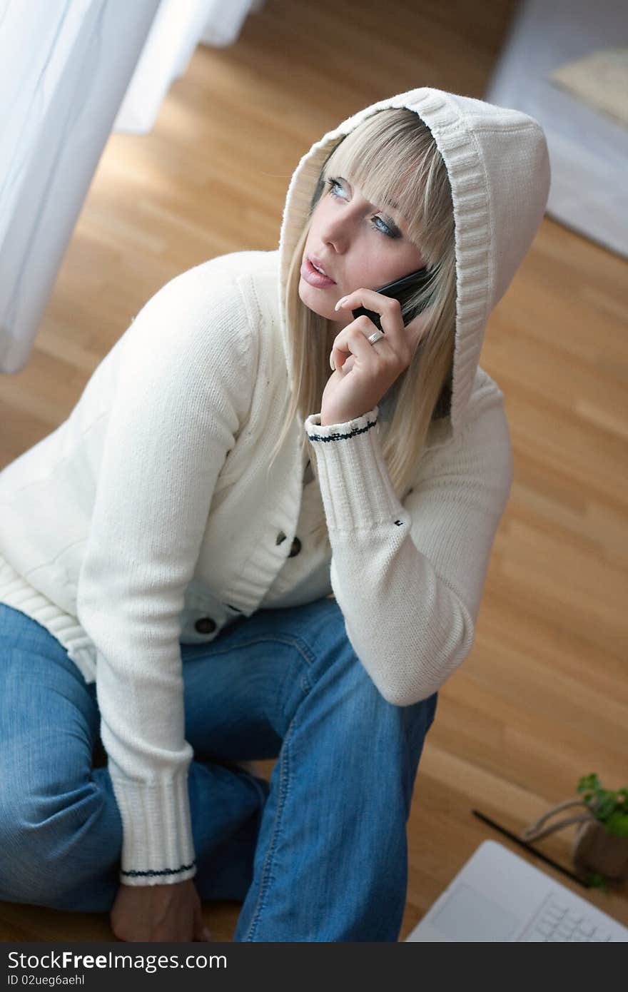 Young blond woman with a mobile phone