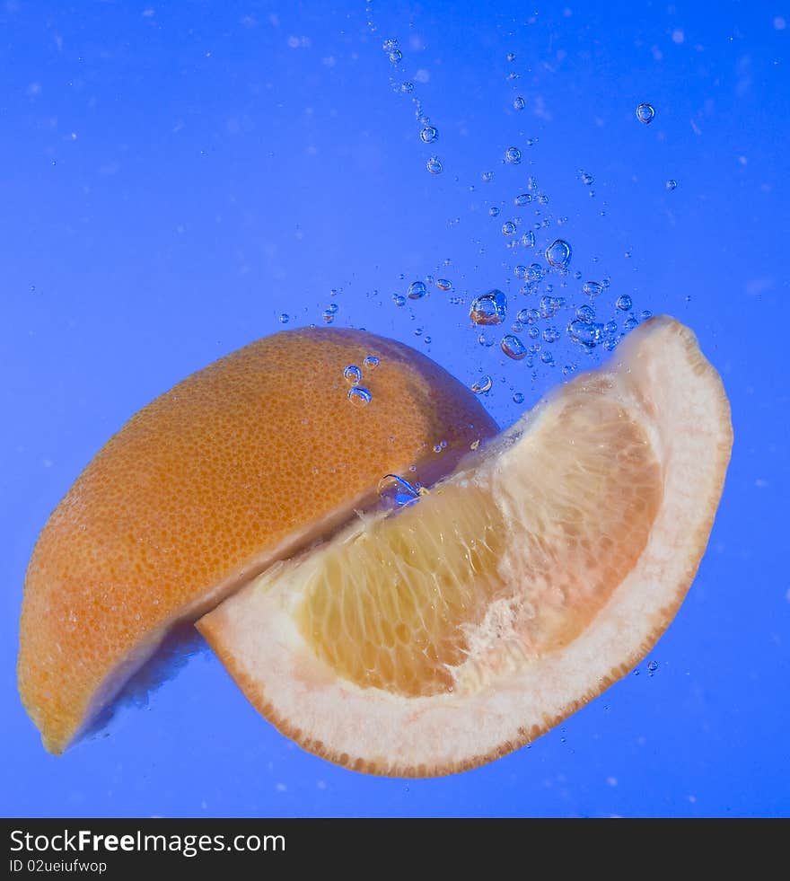 Fresh orange in the blue water. Fresh orange in the blue water