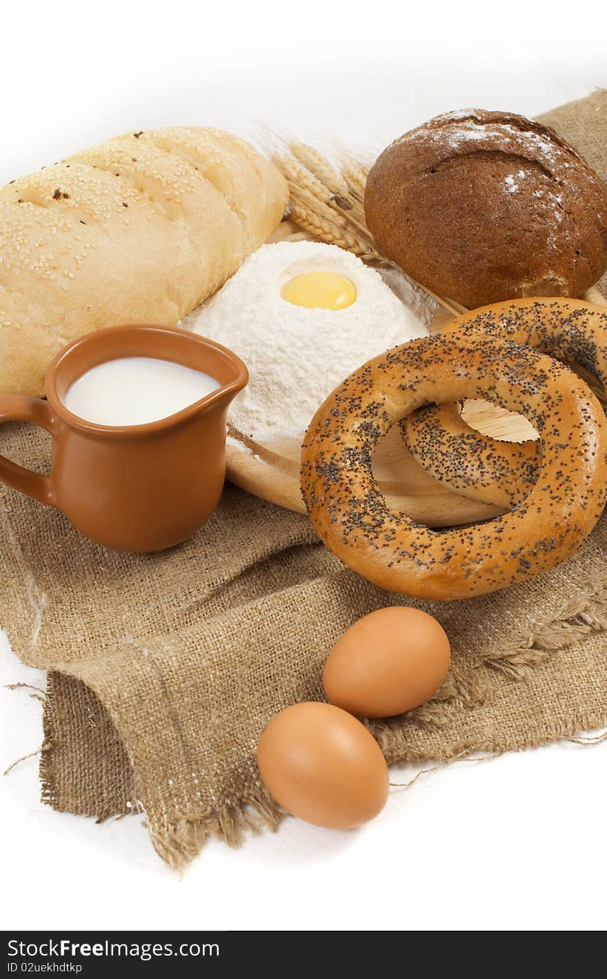 Nice fresh country breakfast with bread, milk and eggs isolated on white background