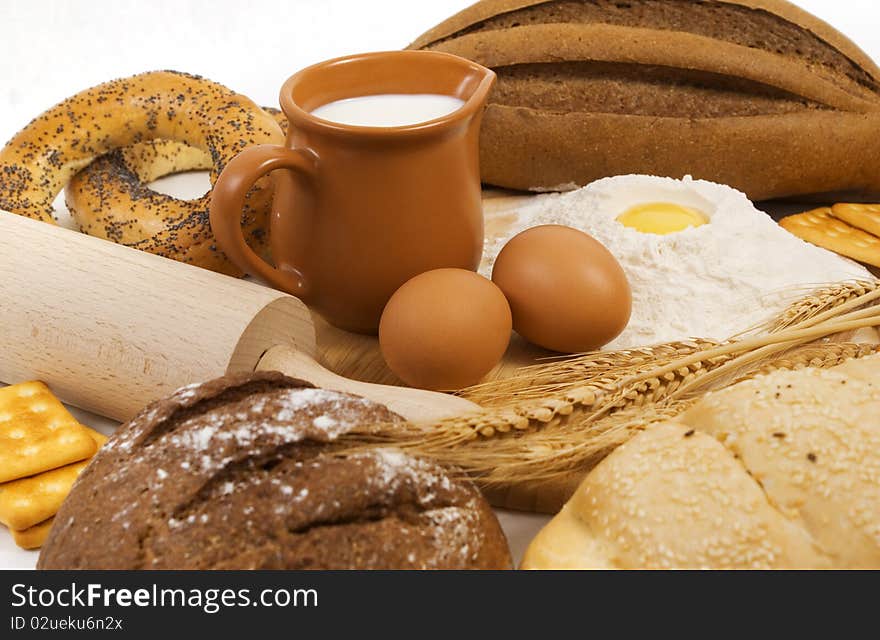 Nice fresh different bread, milk and eggs on white background. Nice fresh different bread, milk and eggs on white background