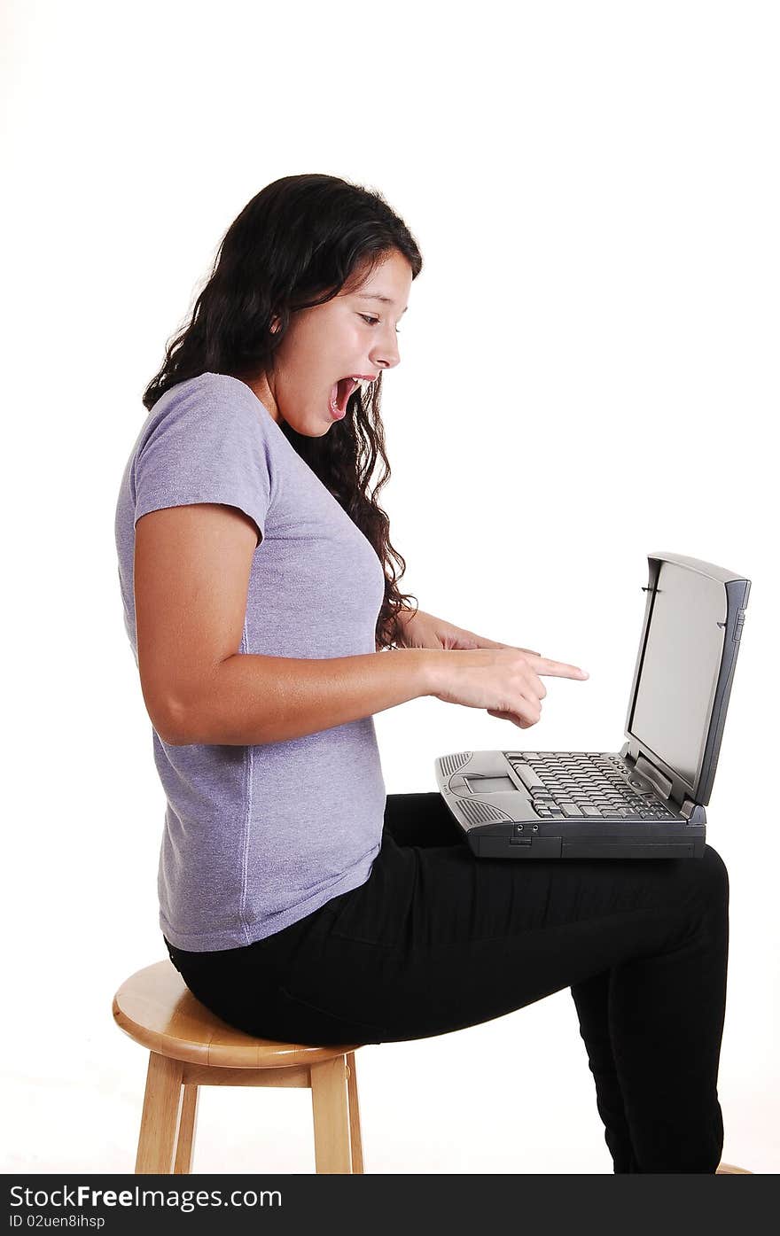 An happy young woman with a laptop on her lap, sitting on a chair in black jeans and is surprised what she sees on the screen, for white background. An happy young woman with a laptop on her lap, sitting on a chair in black jeans and is surprised what she sees on the screen, for white background.