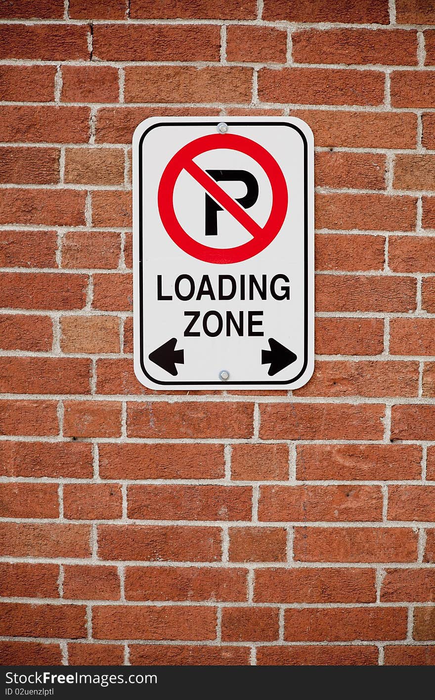 Loading zone sign on brick background