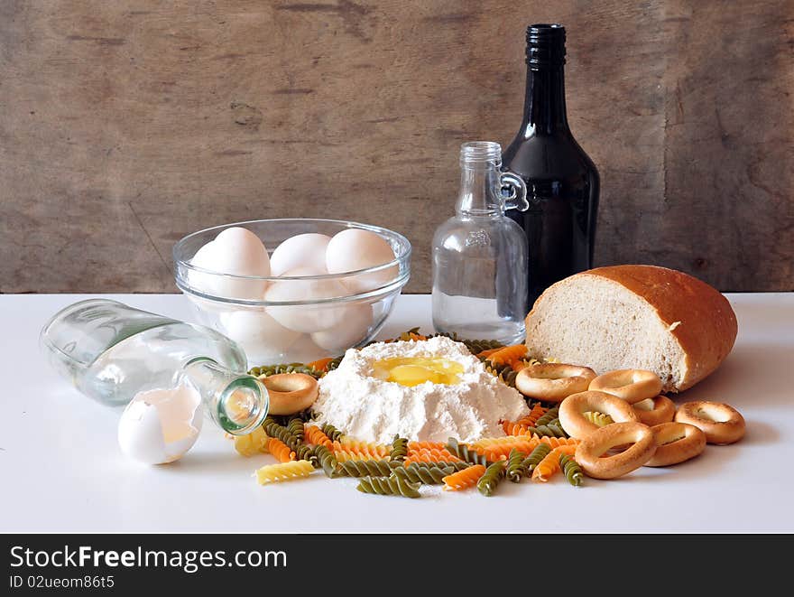 Eggs, flour, bread, bagels, lie on a table, a vermicelli costs two bottles alongside. Eggs, flour, bread, bagels, lie on a table, a vermicelli costs two bottles alongside