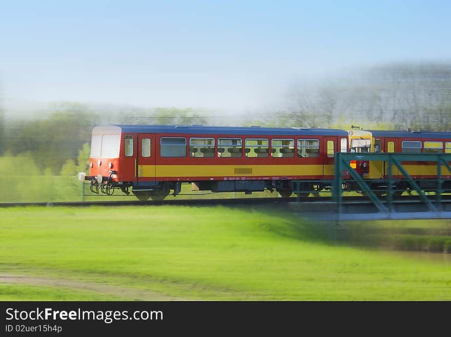 Fast, small, red train running over the bridge. Fast, small, red train running over the bridge