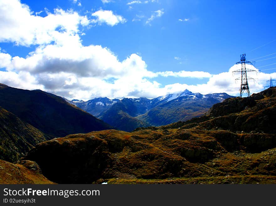 Snow capped mountains over green valley