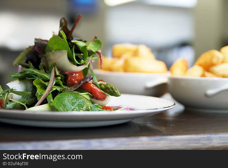 Salad piled high with bowls of chips