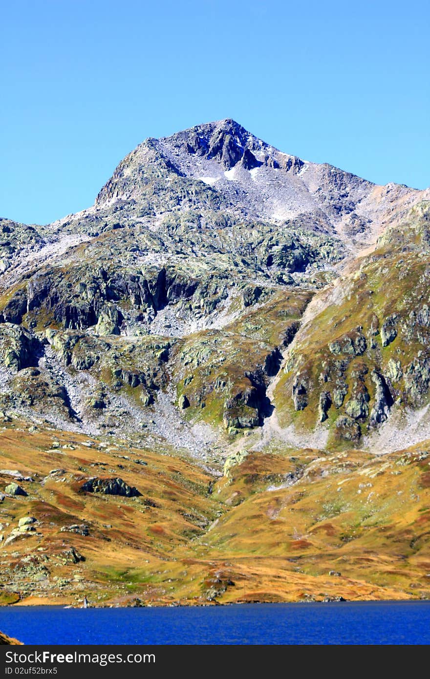 A snow capped Mountain overlooking a dam in Switzerland. A snow capped Mountain overlooking a dam in Switzerland