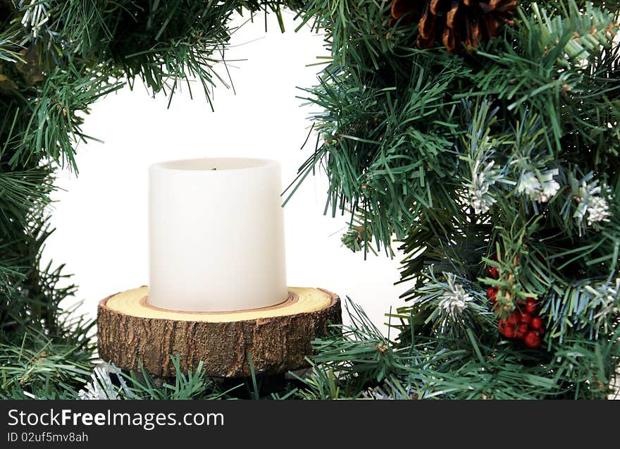 A closeup of an artifical wreath on a white background to celebrate the christmas spirit. A closeup of an artifical wreath on a white background to celebrate the christmas spirit.