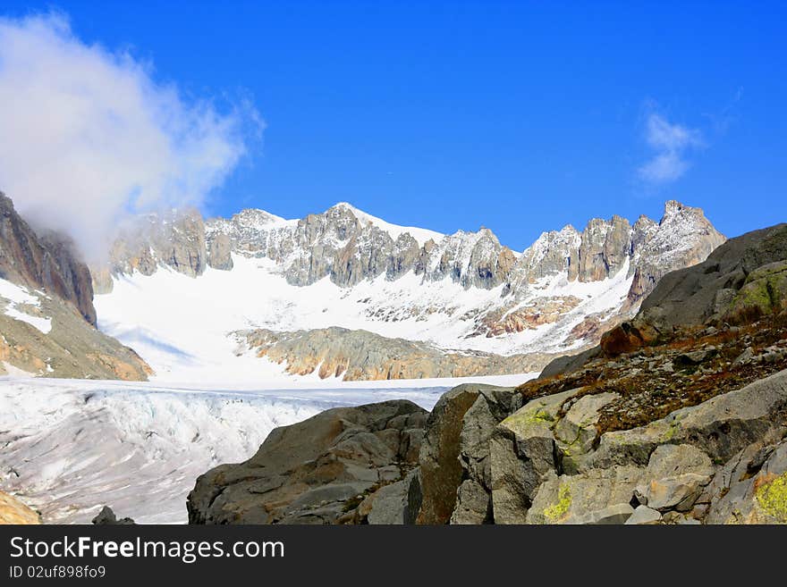 Glacier With Snow Capped Mountains