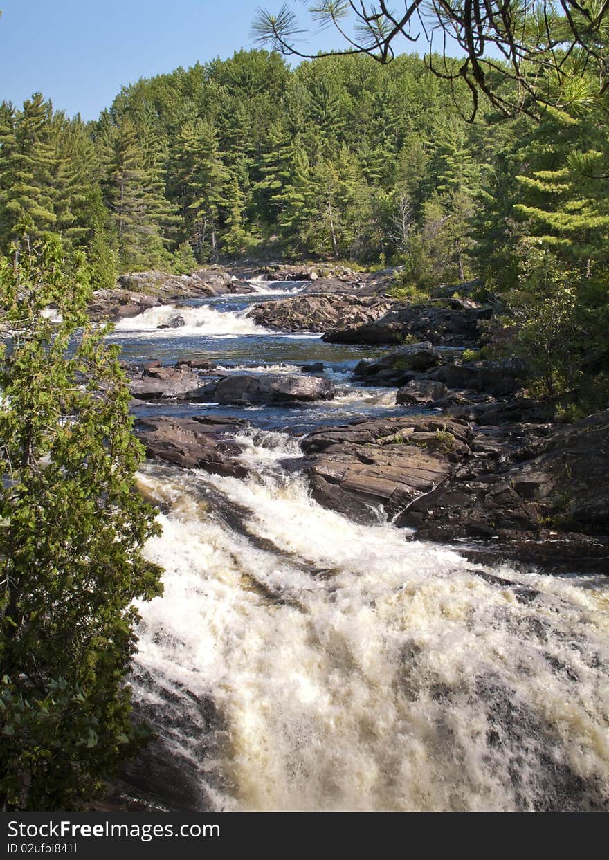 A set rapids in a northern Ontario river, shot in bright daylight. A set rapids in a northern Ontario river, shot in bright daylight.