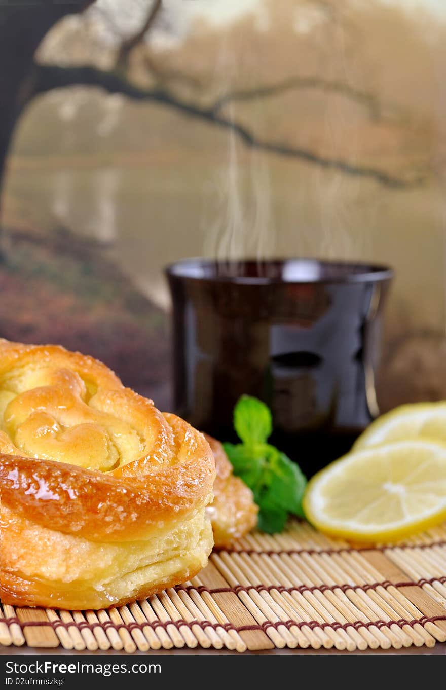 Breakfast with sweet buns, lemon and tea