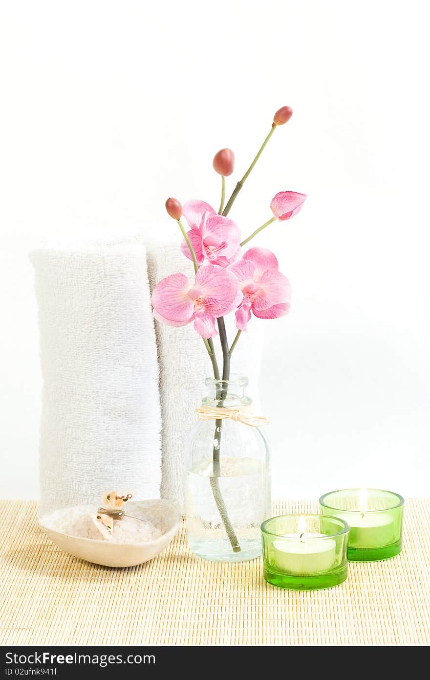 Composition of Pink orchid, towel and two candles