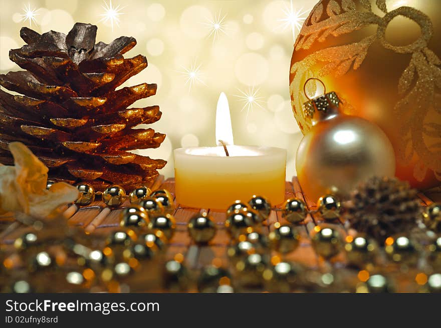 Christmas decoration with balls, fir cone and candlelight