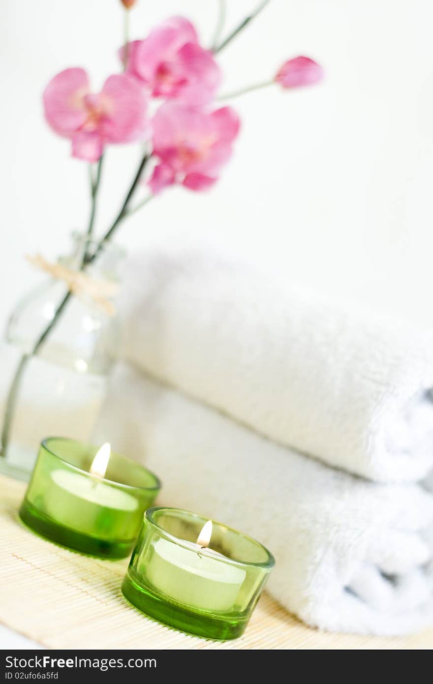 Composition of Pink orchid, towel and two candles