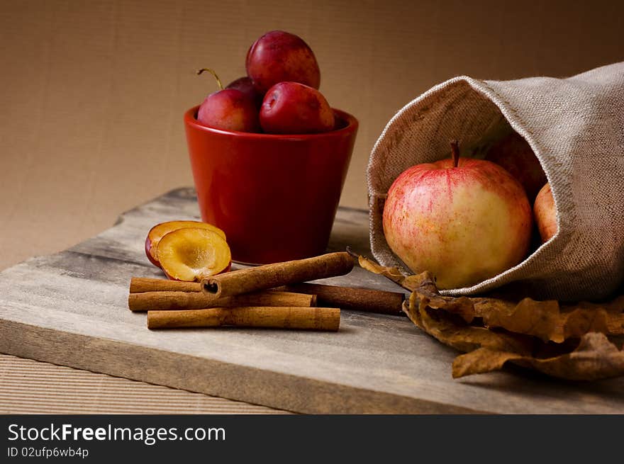 Still-life with apples, plums and cinnamon. Still-life with apples, plums and cinnamon