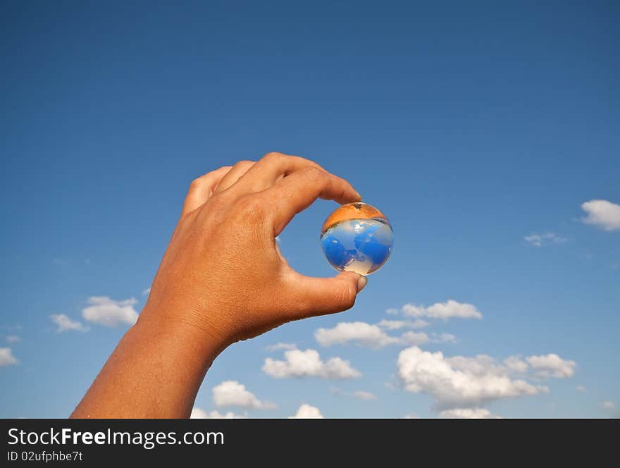 Fragile world - hand with glass globe