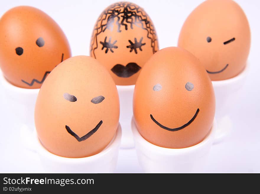 Eggs with a smiling faces on white background